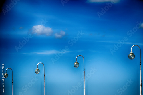  blue sky with white clouds and lanterns on a warm sunny day photo