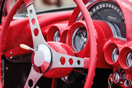 Original red steering wheel in a retro car