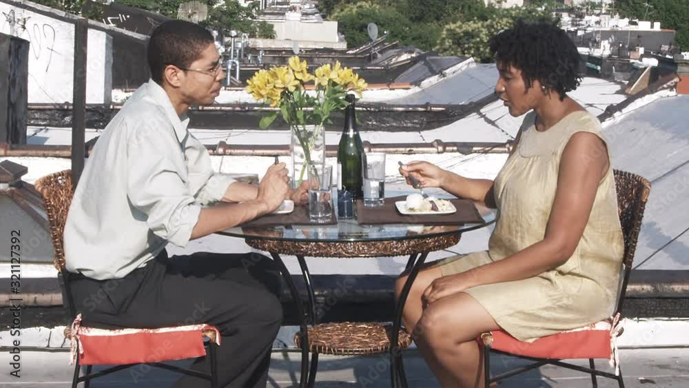 MS, Lockdown, A couple eating a meal on a rooftop terrace MS, Lockdown, A couple eating a meal on a rooftop terrace