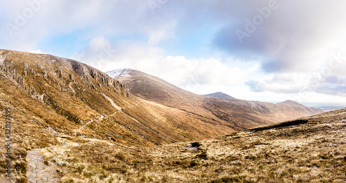 Footpath leading to snow capped peak of Slieve Donard mountain. Mourn Wall surrounding Mourn Mountains  highest range in Northern Ireland