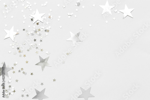 Silver confetti and stars and sparkles on a light background. Top view  flat lay. Copy text. holiday background. For Christmas  New Year  Valentine s Day