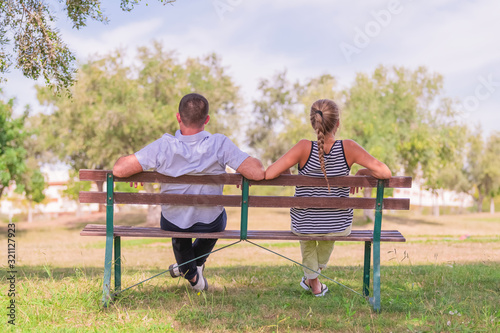 Couple sitting in a bench at a public park