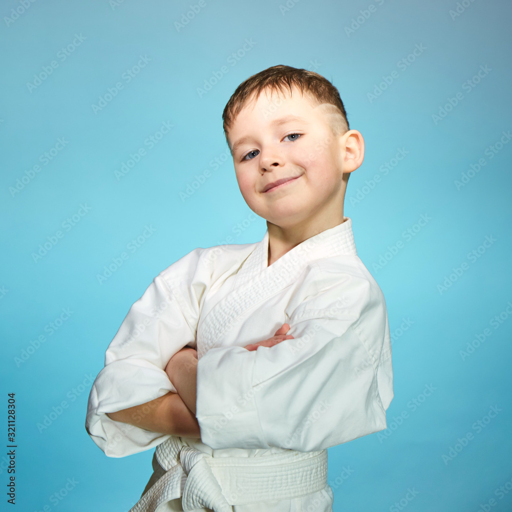 Beautiful little sportsman on a light blue background Beautiful little sportsman on a light blue background
