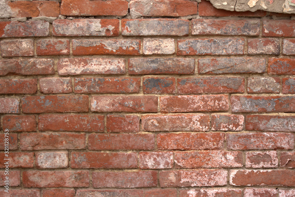 Old weathered red brickwork with stucco remains Old weathered red brickwork with stucco remains