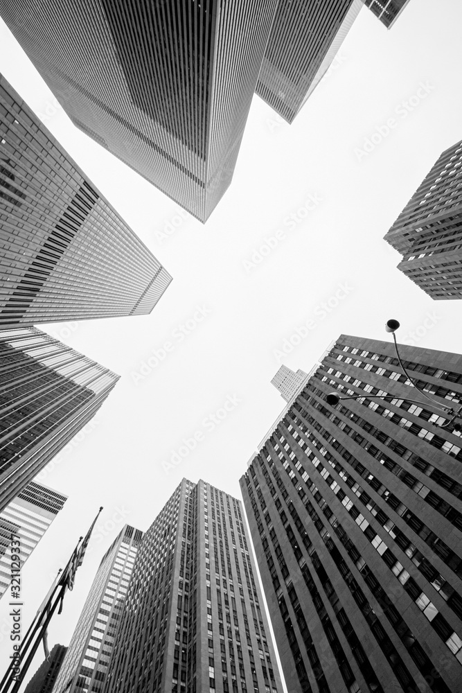 Fototapeta premium look up in New York City, skyscrapers in black and white