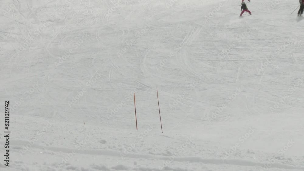 Rear view of people skiing down ski slope Rear view of people skiing down ski slope