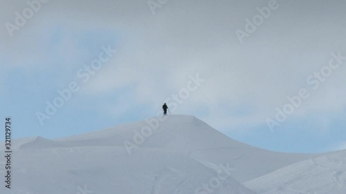 Skier walking on top of snow covered mountain, Verbier, Valais, Switzerland