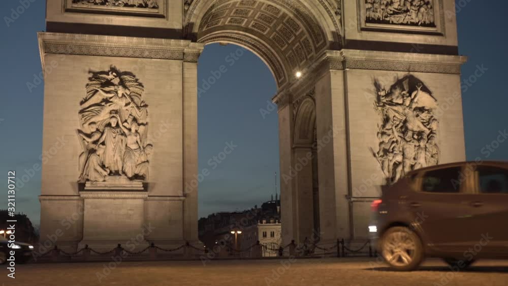 Lockdown shot of cars moving across Arc de Triomphe, Paris, France