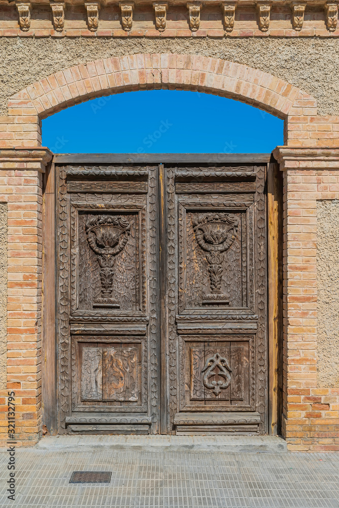 Old massive wooden door of La Giralda in Arboc, province of Tarragona. Spain. Old massive wooden door of La Giralda in Arboc, province of Tarragona. Spain.