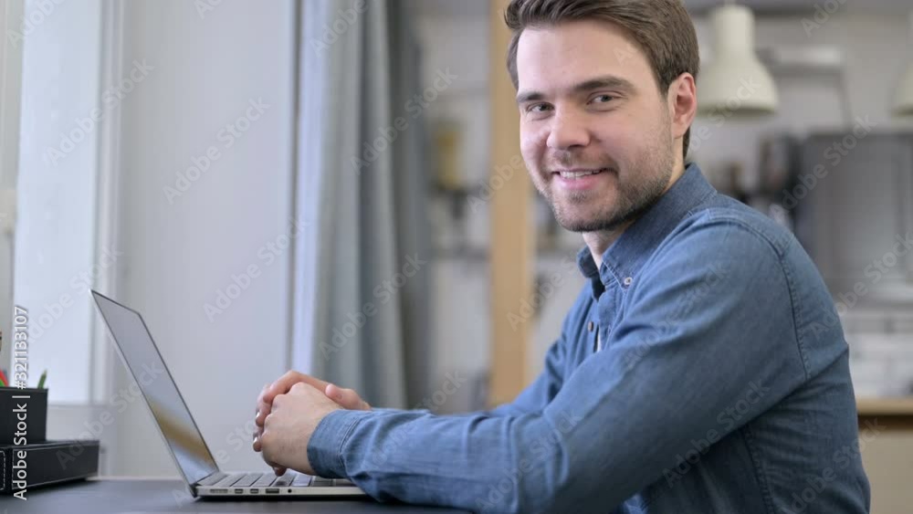 Beard Young Man Smiling at Camera in Office Beard Young Man Smiling at Camera in Office