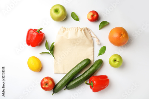 Fototapeta Naklejka Na Ścianę i Meble -  Cotton eco bag, fruits and vegetables on white background, top view