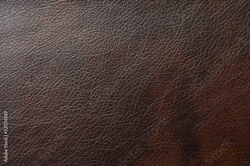Texture of dark brown leather as background, closeup