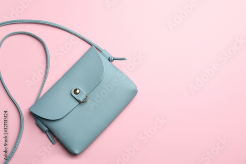 Stylish woman's bag on pink background, top view. Space for text