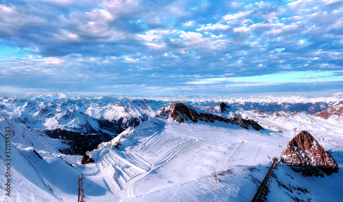 Aerial wide angle panorama of Zell am See and Kaprun tourist resort with sunny Alp mountain summits and white skiing slopes