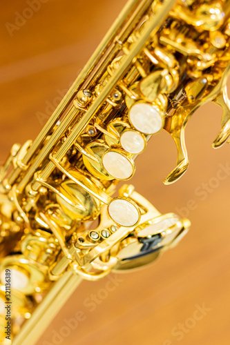 close up on soprano saxophone details, blurred background