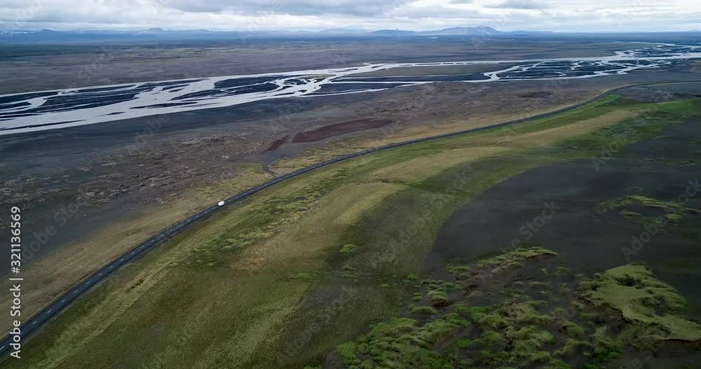 Aerial view car moving on road and river in landscape against cloudy sky, Myvatn, Iceland Aerial view car moving on road and river in landscape against cloudy sky, Myvatn, Iceland