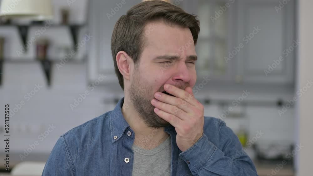 Portrait of Sleepy Beard Young Man Yawning in Office