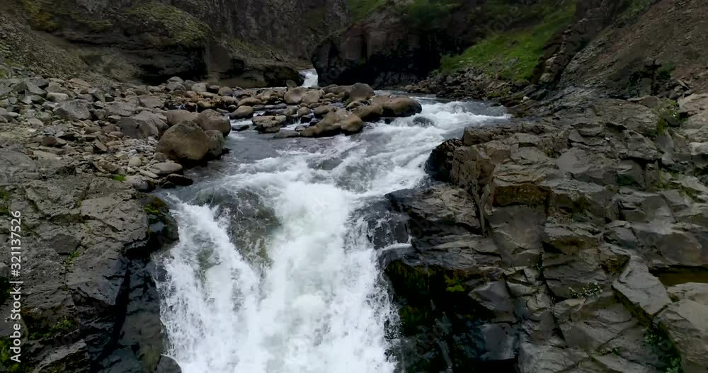 Drone shot of idyllic stream flowing through rocks on mountain, Hengifoss, Vatnajokull, Iceland Drone shot of idyllic stream flowing through rocks on mountain, Hengifoss, Vatnajokull, Iceland