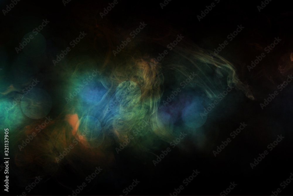 Fototapeta premium Colored smoke over black studio background
