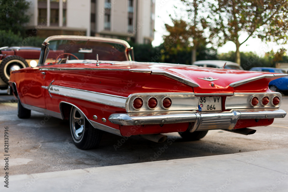 Rear view of a red colored 1960 Chevrolet Impala. Photos | Adobe Stock