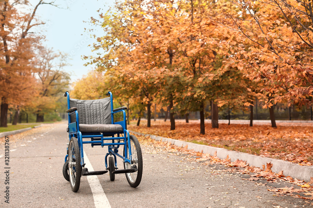 Empty wheelchair in autumn park