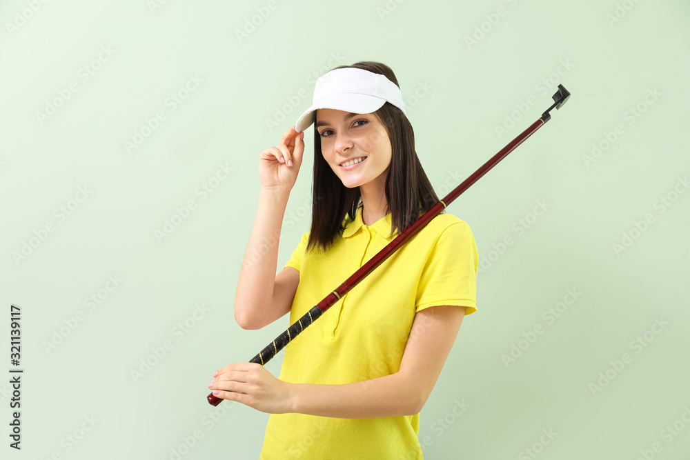 Beautiful female golfer on color background Beautiful female golfer on color background