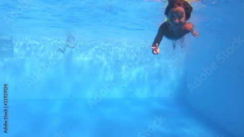 Portrait boy diving underwater in swimming pool