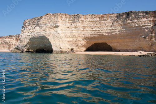 Praia do Mato in the Algarve region  Portugal. Small golden beach  with huge caves and impressive rock formations seen from the sea