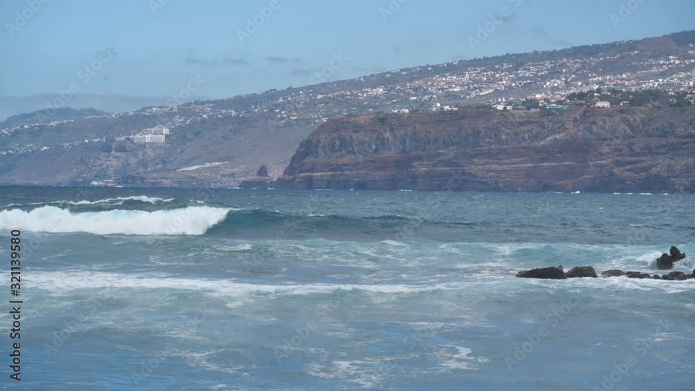 Waves of Atlantic ocean, view from Puerto de la Cruz city, Tenerife island, Canary islands, Spain Waves of Atlantic ocean, view from Puerto de la Cruz city, Tenerife island, Canary islands, Spain