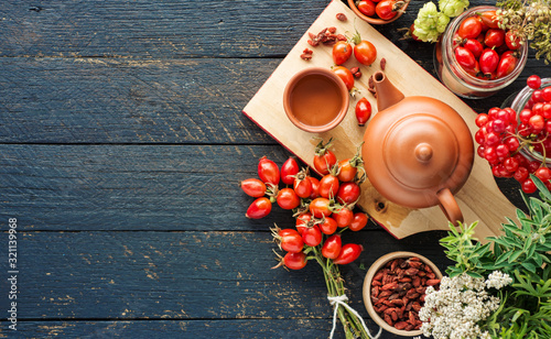 Fényképezés Dog rose, branch Rosehips,  Rosa canina hips essential oil goji berries and cham