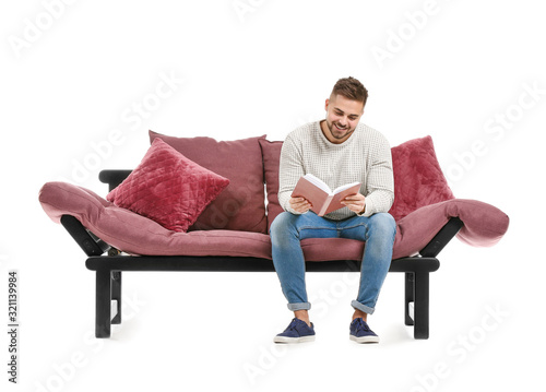 Young man reading book whil...