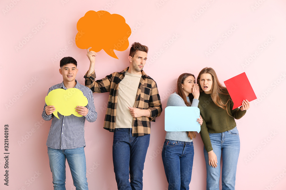 Naklejka premium Group of young people with blank speech bubbles on color background