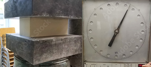 Compression strength test of a brick in press. Pressure indications of the press mechanism.