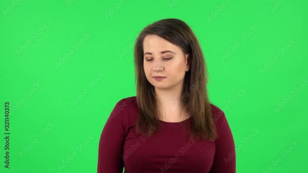 Portrait of pretty girl coquettishly smiling while looking at camera. Green screen Portrait of pretty girl coquettishly smiling while looking at camera. Green screen