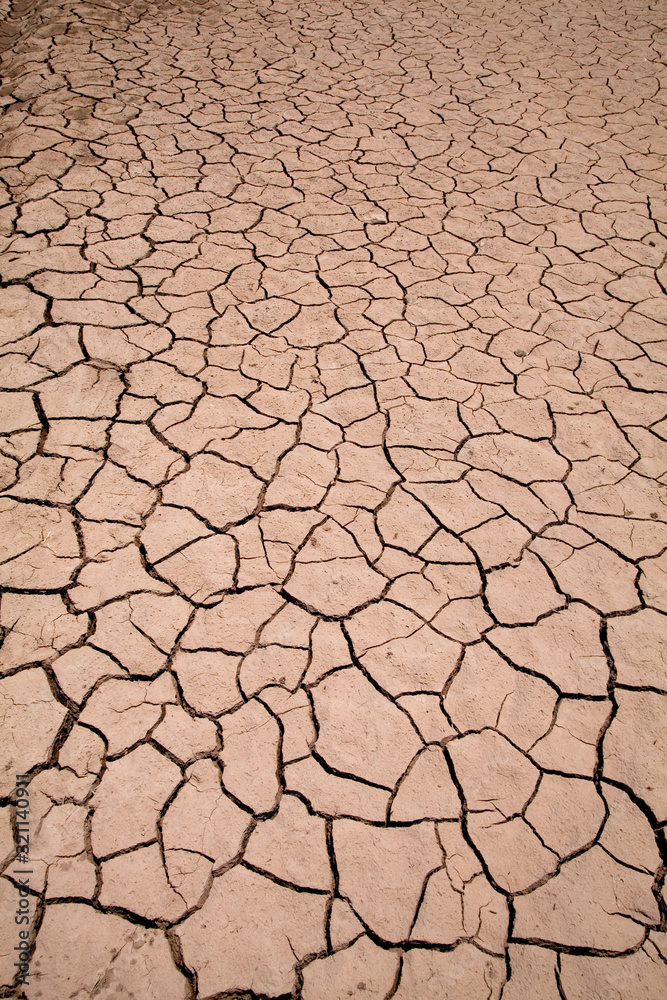 Dry earth with cracks after water has receeded or evaporated Dry earth with cracks after water has receeded or evaporated