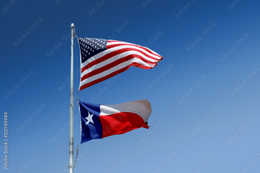 The flags of the United States and of the State of Texas on one flag-pole.