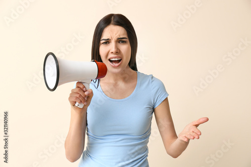Emotional woman with megaph...
