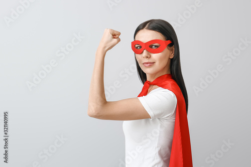 Woman in superhero costume ...