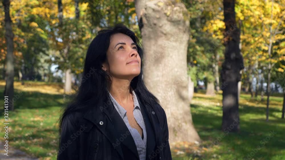 Romantic Pretty Girl Walking In City Park Looking At Trees Leaves. Autumn Sunny Morning. Slow motion 4K 60 fps Romantic Pretty Girl Walking In City Park Looking At Trees Leaves. Autumn Sunny Morning. Slow motion 4K 60 fps