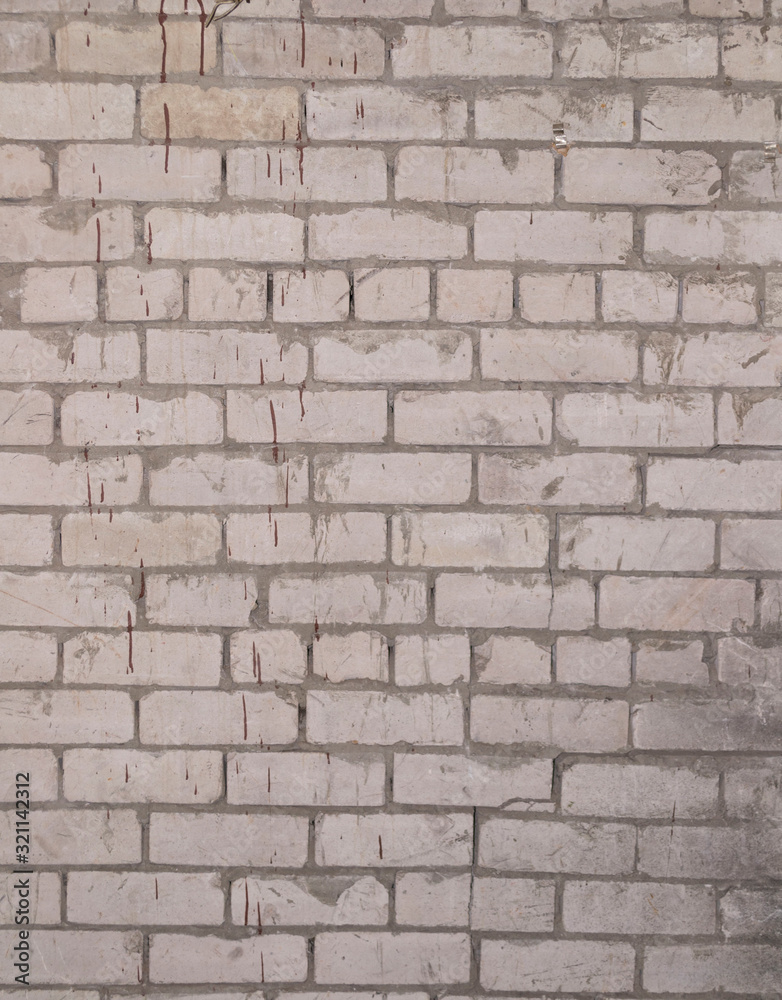 top view of a brick wall stained with drops of brown paint top view of a brick wall stained with drops of brown paint