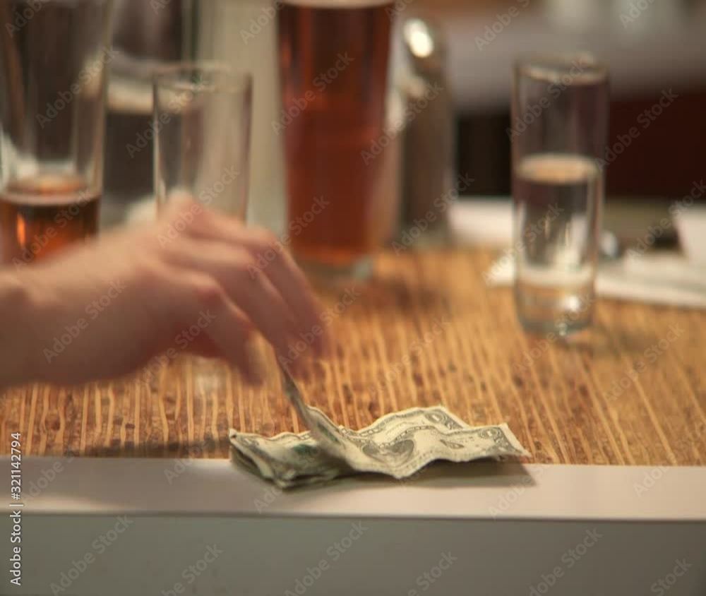 CU, Lockdown of a bar littered with empty and half-emptied glasses and human hand counting money CU, Lockdown of a bar littered with empty and half-emptied glasses and human hand counting money