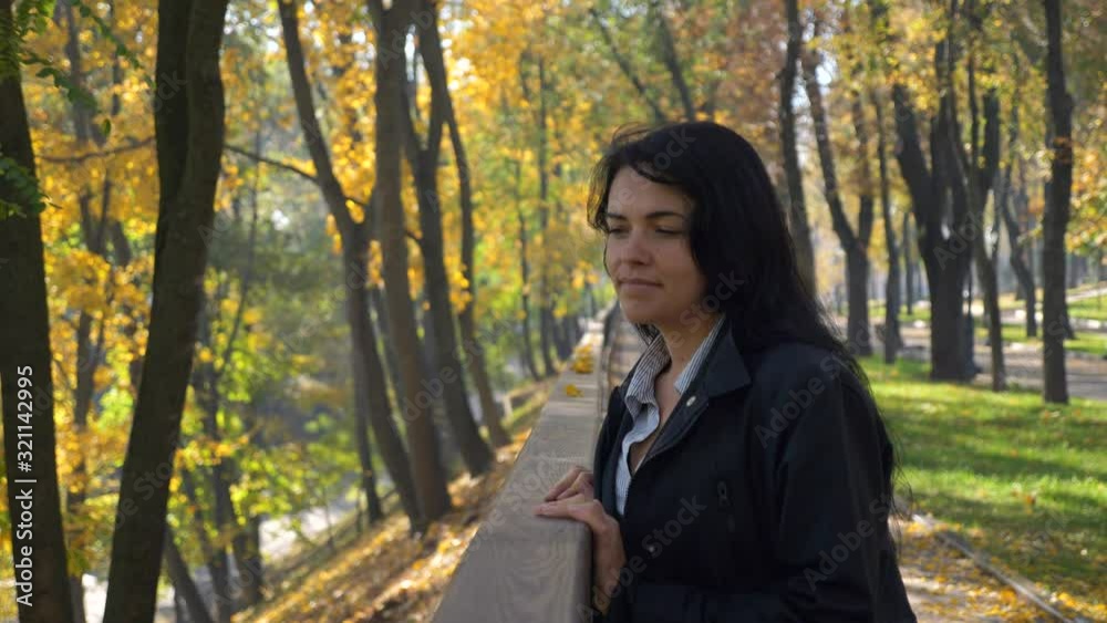 Romantic Pretty Girl Walking In City Park Looking At Trees Leaves. Autumn Sunny Morning. Slow motion 4K 60 fps Romantic Pretty Girl Walking In City Park Looking At Trees Leaves. Autumn Sunny Morning. Slow motion 4K 60 fps