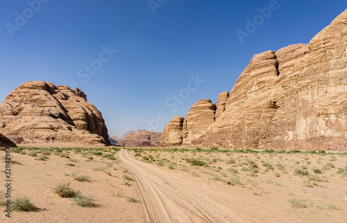 Magic mountain landscapes of Wadi Rum Desert, Jordan. Mountains in lifeless desert resemble Martian craters. Red sand and red rocks. There is place for text.