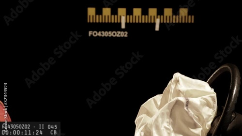 Lockdown, CU, SLO MO, head and shoulders of a crash test dummy hitting a deployed airbag 
