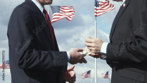 CU, Lockdown of one man giving another man a bribe in front of American flags, Washington DC