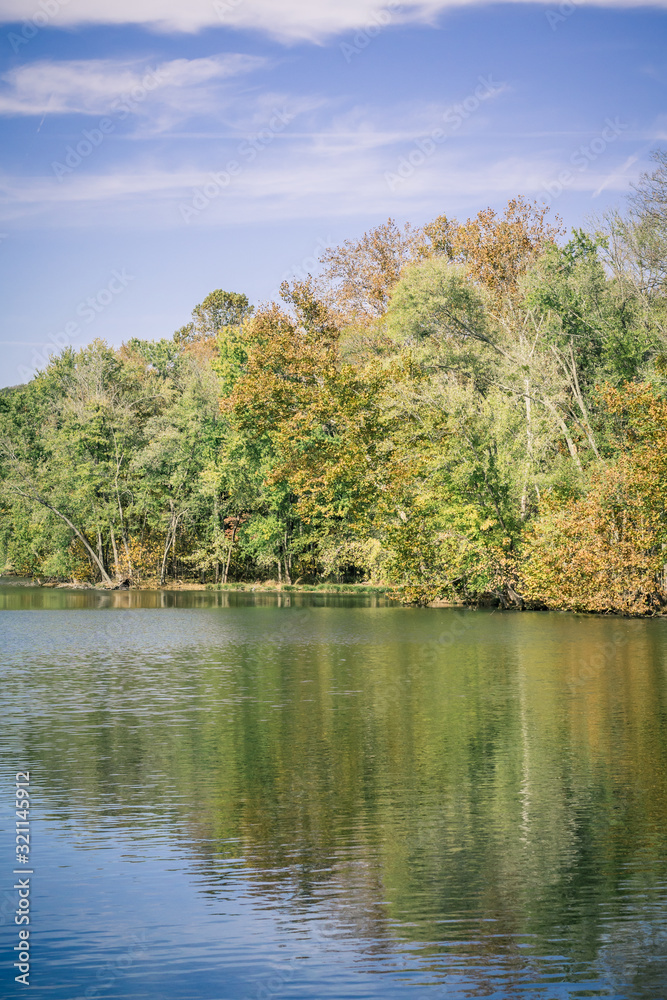 Autumn Trees Reflected in Lake on a Sunny Day Autumn Trees Reflected in Lake on a Sunny Day