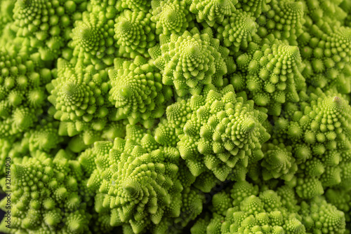 Romanesco broccoli on a dark wooden background. For vegans and a healthy diet. Copy space photo