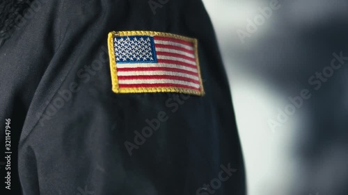 American flag patch on the arm of a security contractor uniform