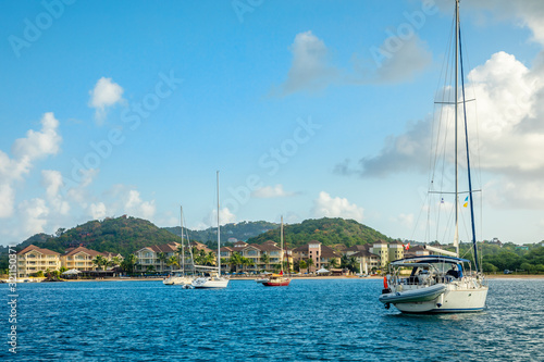 Offshore view of Rodney bay with yachts anchored in the lagoon and rich resorts in the background  Saint Lucia  Caribbean sea