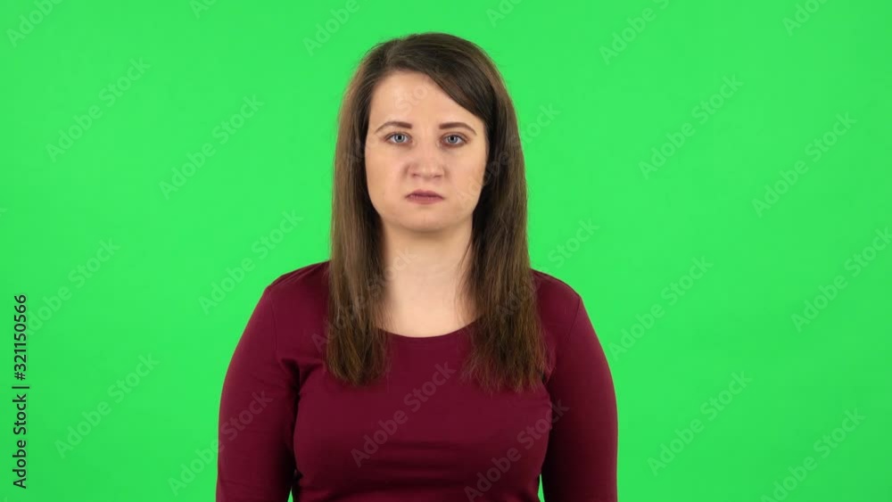 Portrait of angry girl is waving her hands in indignation, shrugs. Green screen Portrait of angry girl is waving her hands in indignation, shrugs. Green screen